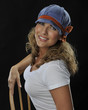 beautiful woman in white T-shirt blue hat black background