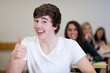 Happy Student has fun while working in classroom
