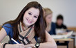 Happy Student has fun while working in classroom