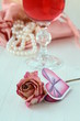 White pearls in a pink bag with a rose romantic concept White pearls in a pink bag with a rose romantic concept