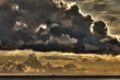 Small ship with threatening clouds over South China Sea