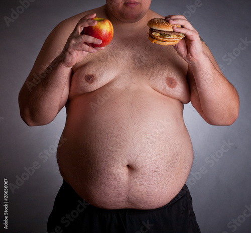 fat person eating burger. Fat man with urger and apple