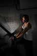 Asian Chinese Man carrying a pistol in staircase