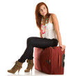 Woman sitting on her suitcase Woman sitting on her suitcase