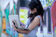 Teen with laptop in school yard