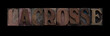the word lacrosse in old letterpress wood type