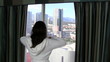 Video: Vacationing woman looks out hotel window - HD Vacationing woman looks out hotel window - HD
