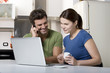 couple in the kitchen with laptop