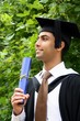 A portrait of a young Indian guy in a graduation gown.