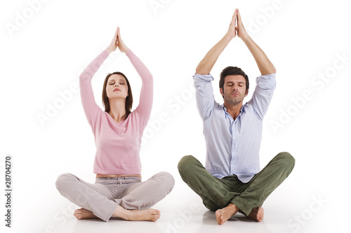 Photo: Couple practicing yoga Couple practicing yoga