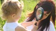 mother and daughter are looking at each other throw loupe