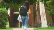 Young woman at school running to class