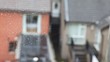 spiderweb waving by wind, Irish houses on background