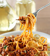 spaghetti hanging on a fork at dinner