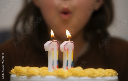 Photo: Girl Blowing Out Candles On A Birthday Cake Girl Blowing Out Candles On A Birthday Cake