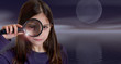Girl holding magnifying glass on moonlight
