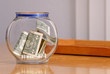 Swear Jar with Money on Table