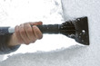 scraping snow and ice from the car windscreen scraping snow and ice from the car windscreen