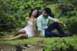 eurasian siblings lounging in a field in hawaii eurasian siblings lounging in a field in hawaii
