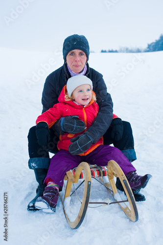 Foto: mother and daughter on a sled mother and daughter on a sled