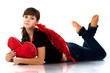 Beautiful girl lying with heart shaped red pillow Beautiful girl lying with heart shaped red pillow