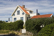 Wooden house with a big hedge
