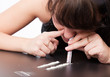 a girl is sniffing cocaine (imitation)