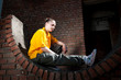 Teenage hip-hop girl on red brick wall