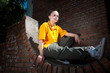 Teenage hip-hop girl on red brick wall