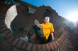 Teenage hip-hop girl on red brick wall