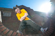 Teenage hip-hop girl on red brick wall