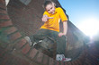 Teenage hip-hop girl on red brick wall