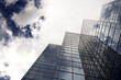 Modern office building with cloud reflection in window.