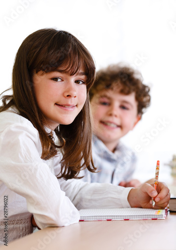 Photo: Girl and boy learning Girl and boy learning