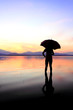 silhouette of young woman against summer sunset