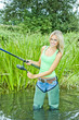woman fishing in pond