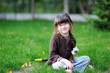 Adorable little girl sits on the grass Adorable little girl sits on the grass