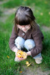 Adorable little girl plays with yellow leaves near the house Adorable little girl plays with yellow leaves near the house