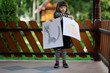 Little girl in halloween outfit shows her draws Little girl in halloween outfit shows her draws