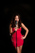 Beautiful singer singing with microphone