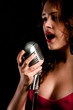 Beautiful singer singing with microphone