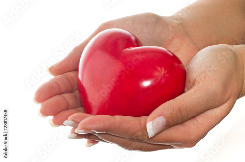 Photo: Female hands holding shiny heart Female hands holding shiny heart