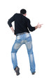 Young man dancing. Rear view. Young man dancing. Rear view.