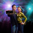 Boy and girl in a club showing card with “your text”