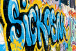 Abstract graffiti detail on the textured brick wall