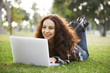 Woman working on her laptop in a park.