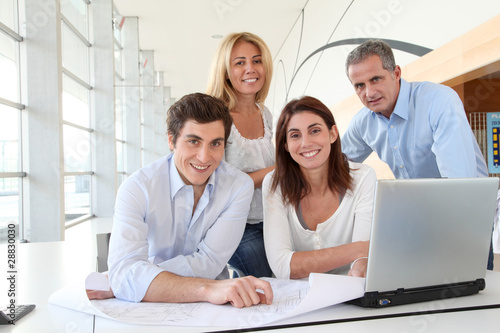 Photo: Office workers in business meeting Office workers in business meeting