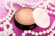 makeup powder on pink background