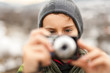 Little boy taking pictures outdoor