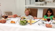 Family praying together during the lunch